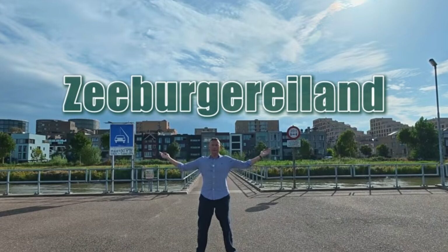 Elwin van Dulst on the bridge onto Zeeburgereiland, with the island’s new-build housing behind him